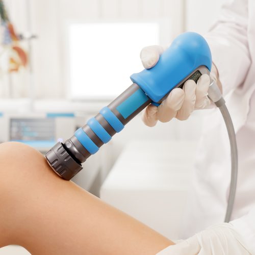 Extracorporeal Shockwave Therapy ESWT. Effective non-surgical treatment for pain. Physical therapy of knee with shock waves. Pain relief, normalization and regeneration, stimulation of healing process
